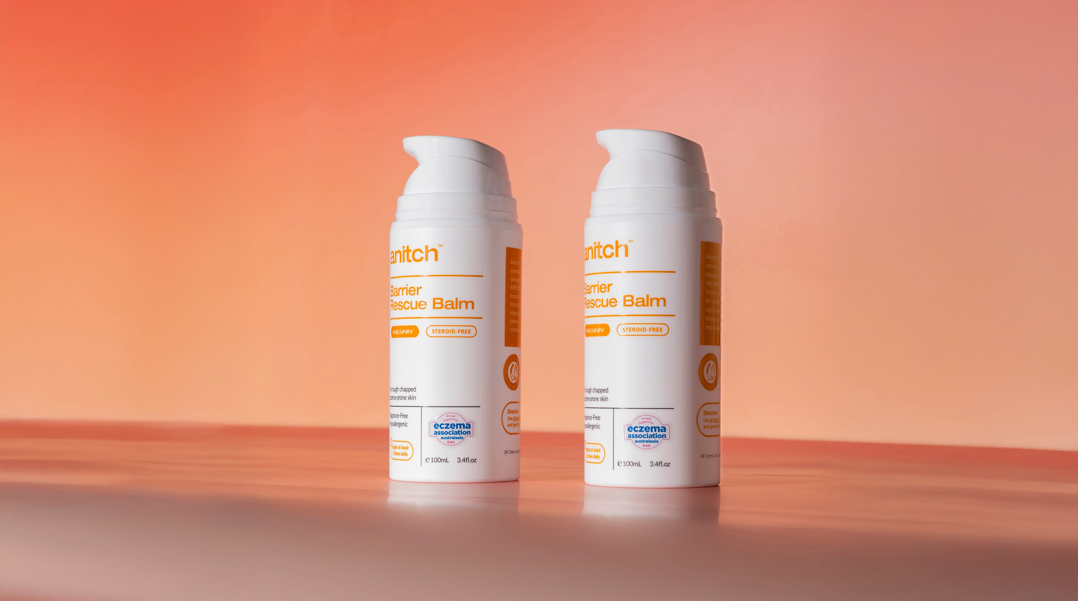 Two bottles of Anitch balm on a gradient background