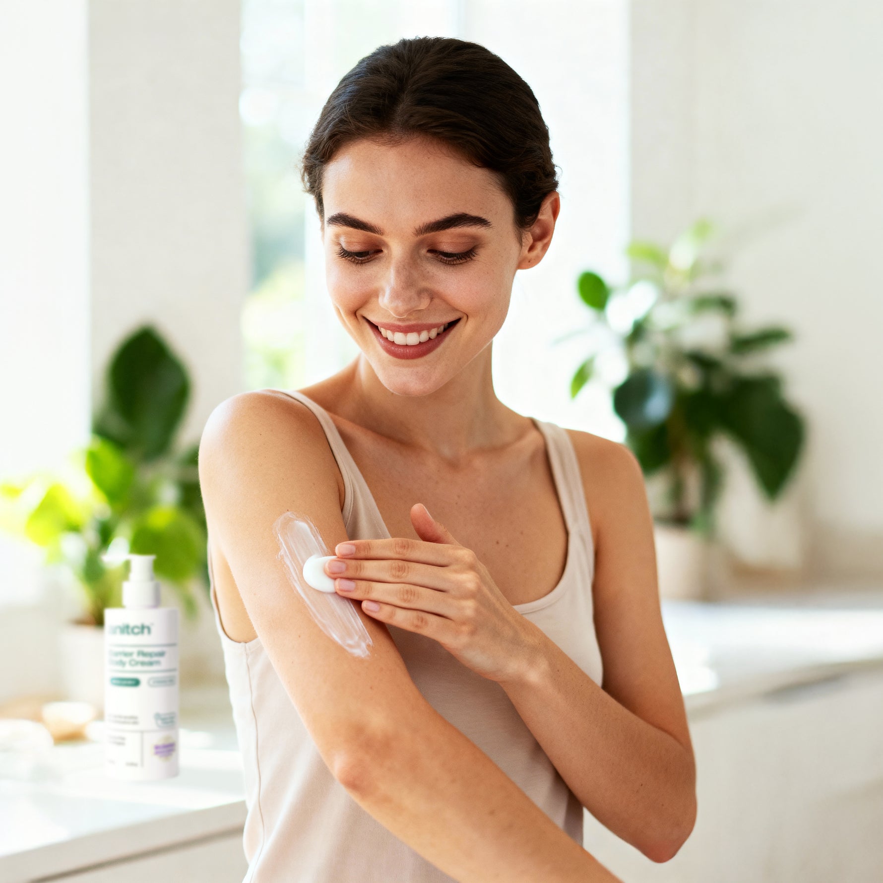 Woman applying some cream on her arm with a blurred background